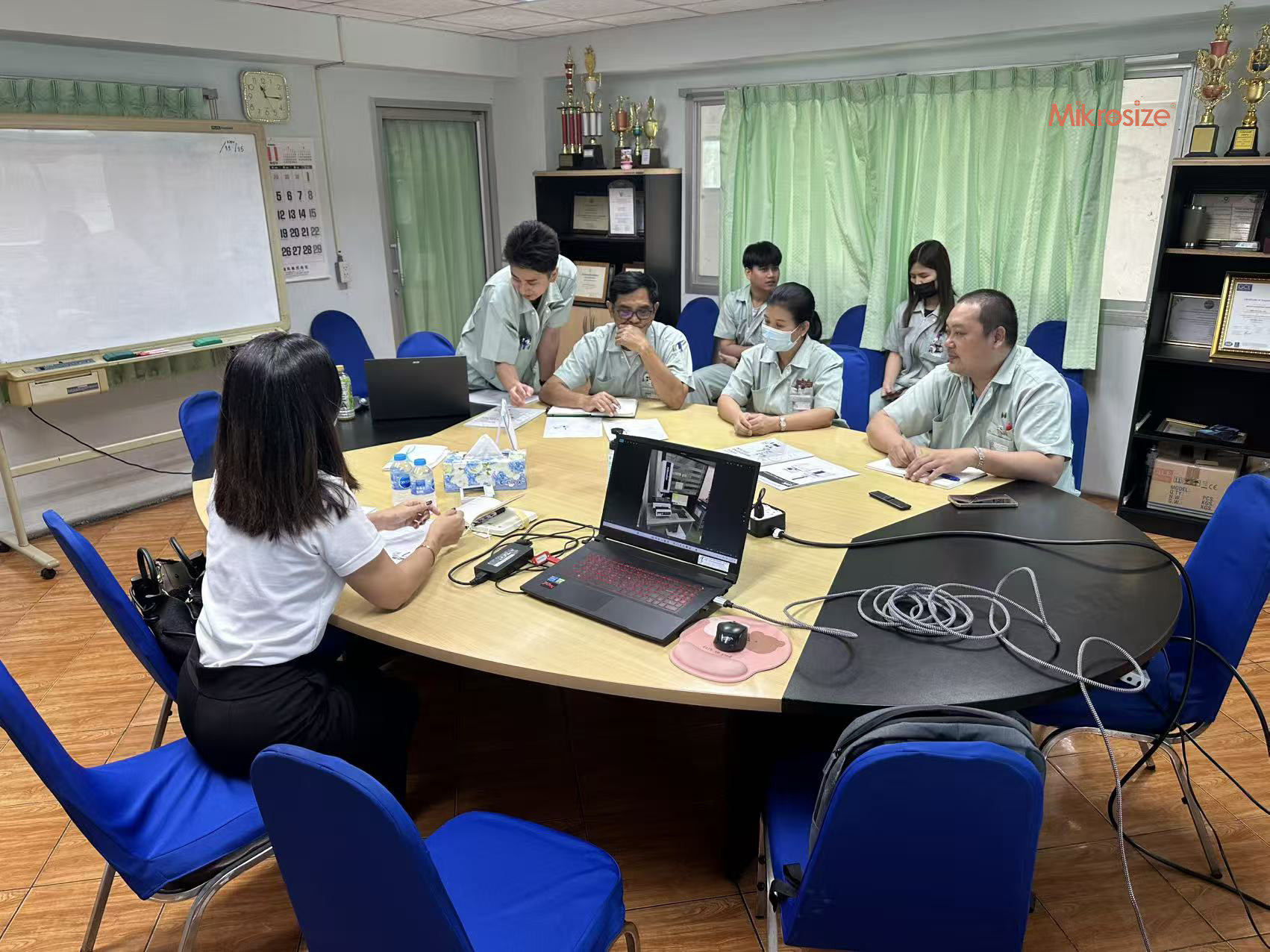 A Mikrosiez sales rep is demonstrating a Video Measuring System to a Thai customer.